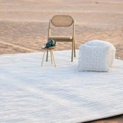 Large beige minimalist textured area rug with a low-relief wave pattern, ideal for modern floor mats or living room area coverage.