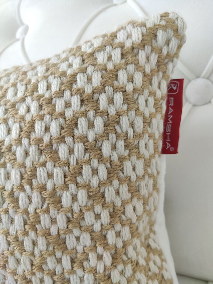 Handcrafted cushion with intricate embroidery for a living room decor upgrade by Ramsha Home.