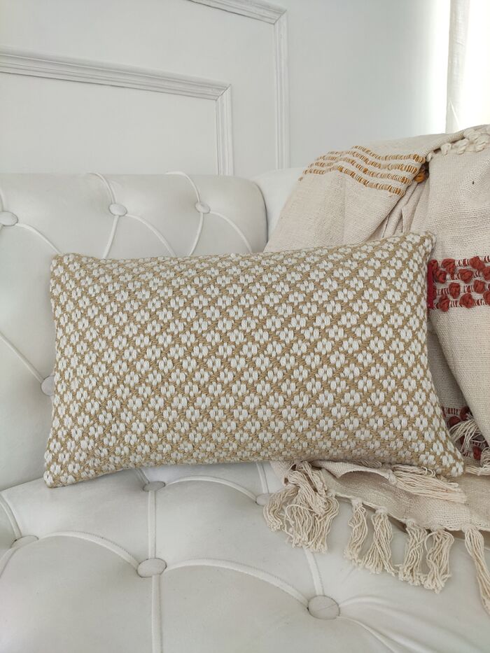 Handmade embroidery cushion CS-250 on a sofa in a bedroom setting by Ramsha Home.