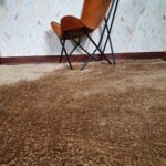 Sideways View of MPS-03 A Beige Shaggy Rug with Leather Chair - Ramsha Home