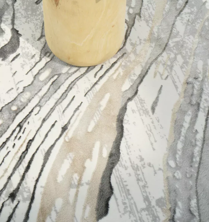 Durable machine-made rug with modern patterns, soft finish, and versatile design for home décor.