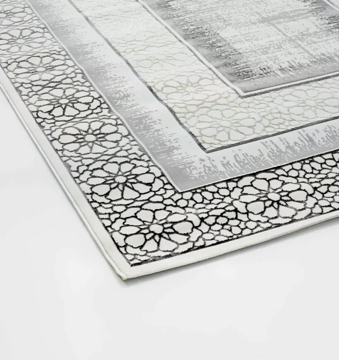 Durable machine-made rug with modern patterns, soft finish, and versatile design for home décor.