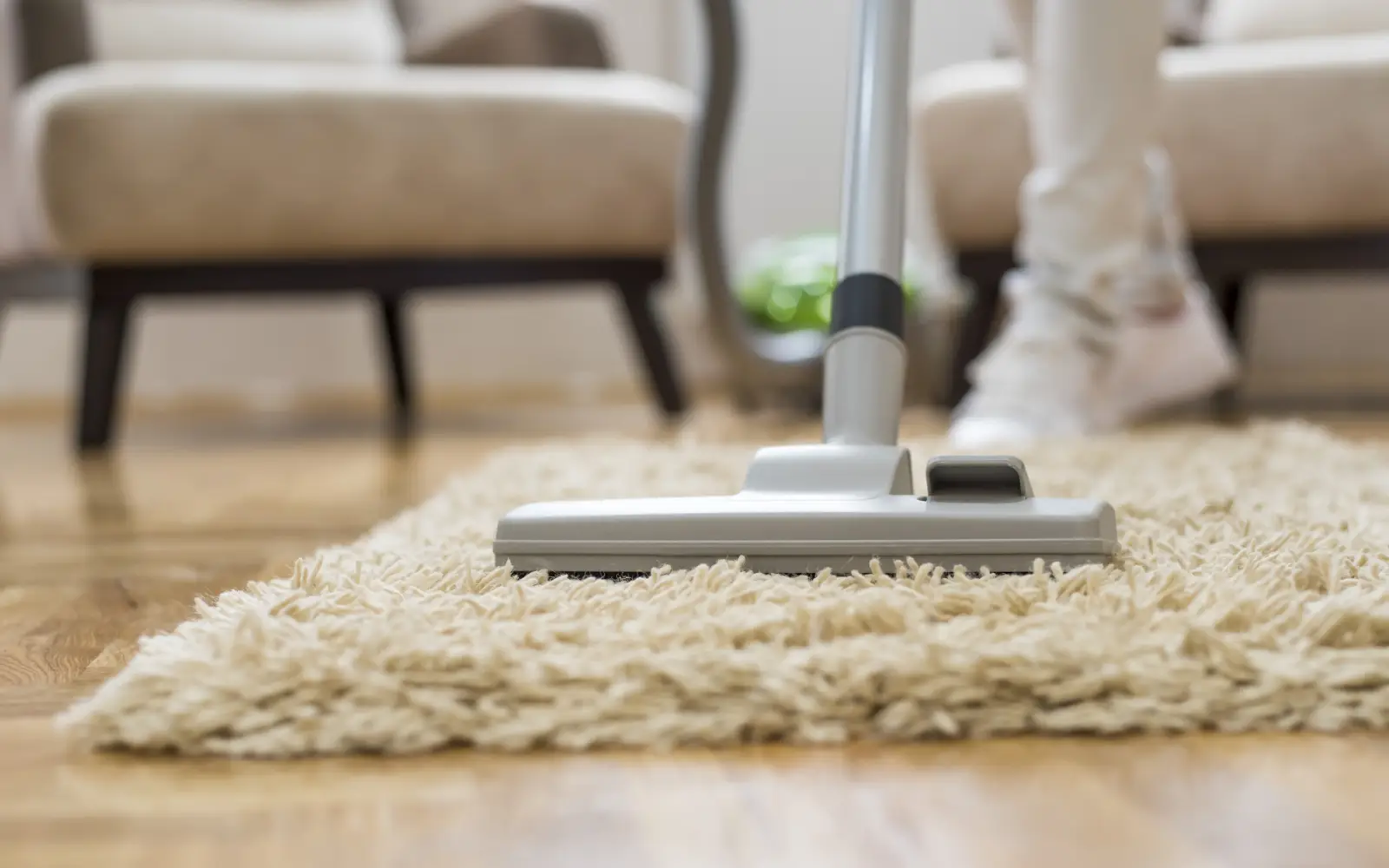 Vacuuming a carpet for professional rug cleaning Dubai