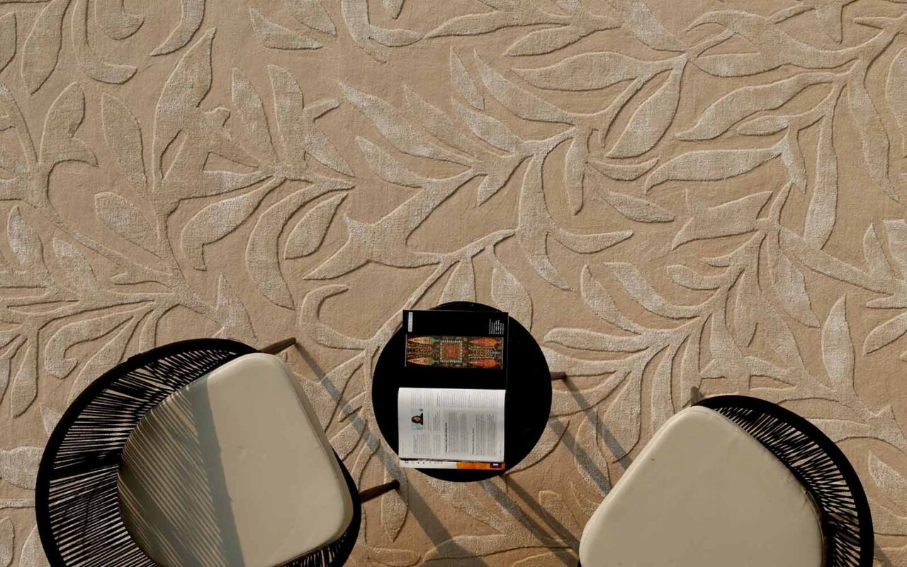 Neutral rug underneath a black chair and round table, enhancing the stylish interior decor.