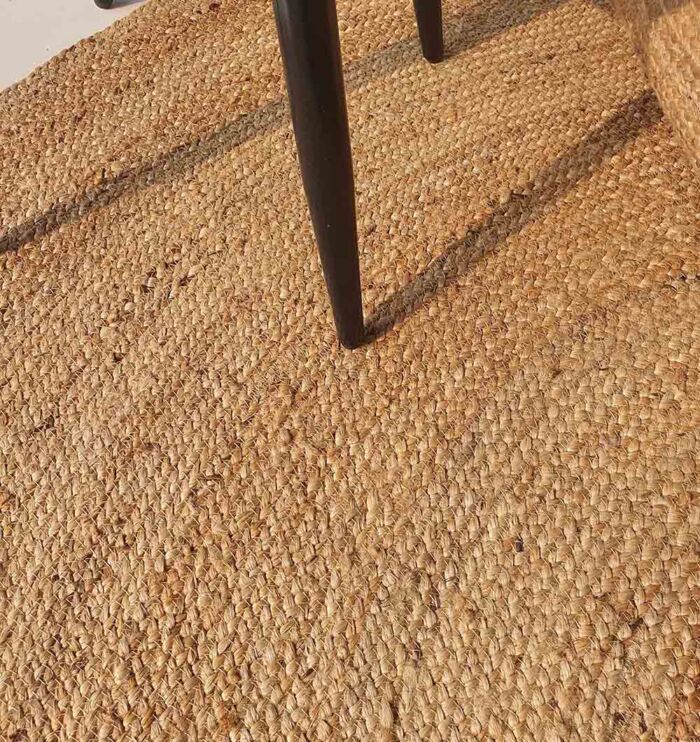 Handmade natural braided jute rug with eco-friendly design, rustic charm, and durable craftsmanship.