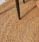 Handmade natural braided jute rug with eco-friendly design, rustic charm, and durable craftsmanship.