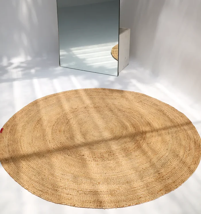 Handmade natural braided jute rug with eco-friendly design, rustic charm, and durable craftsmanship.
