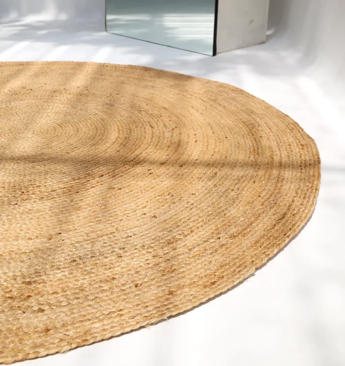 Handmade natural braided jute rug with eco-friendly design, rustic charm, and durable craftsmanship.