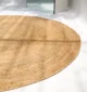 Handmade natural braided jute rug with eco-friendly design, rustic charm, and durable craftsmanship.