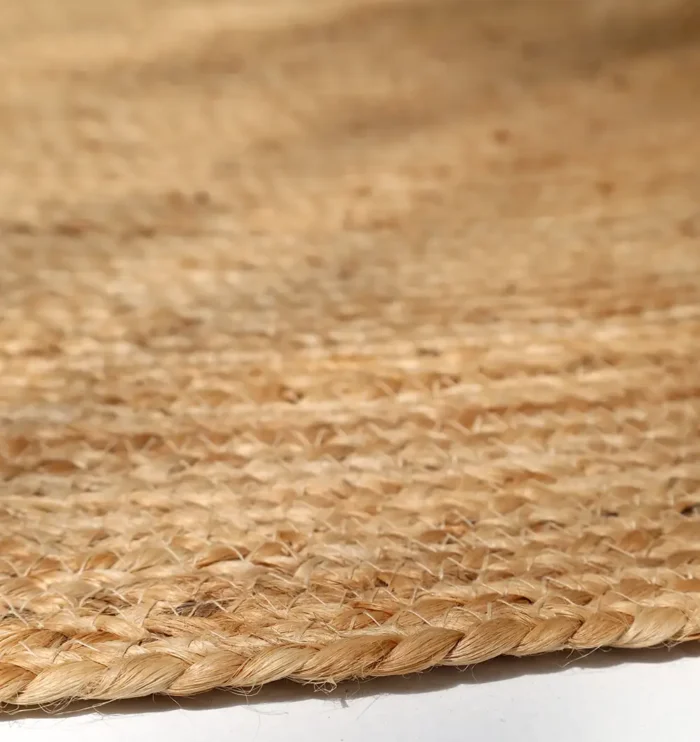 Handmade natural braided jute rug with eco-friendly design, rustic charm, and durable craftsmanship.