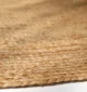 Handmade natural braided jute rug with eco-friendly design, rustic charm, and durable craftsmanship.