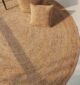 Handmade natural braided jute rug with eco-friendly design, rustic charm, and durable craftsmanship.