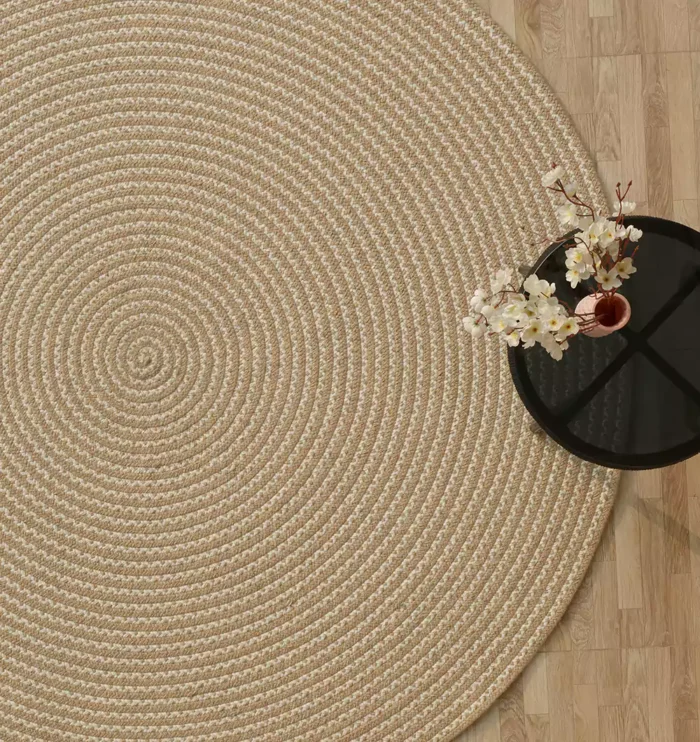 Handmade natural braided jute rug with eco-friendly design, rustic charm, and durable craftsmanship.
