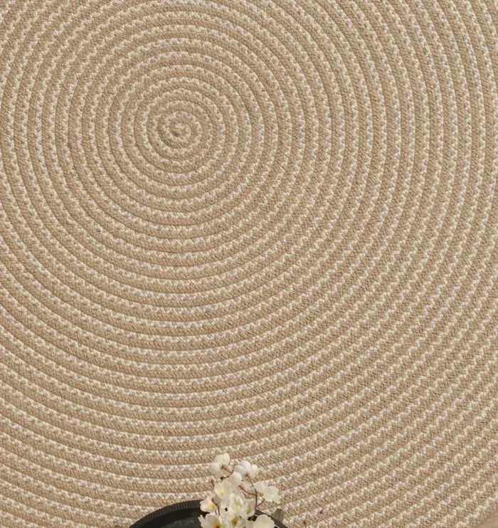 Handmade natural braided jute rug with eco-friendly design, rustic charm, and durable craftsmanship.