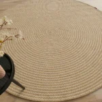 Handmade natural braided jute rug with eco-friendly design, rustic charm, and durable craftsmanship.
