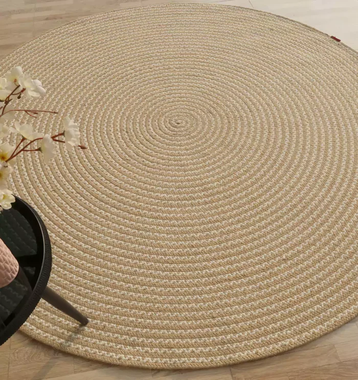Handmade natural braided jute rug with eco-friendly design, rustic charm, and durable craftsmanship.