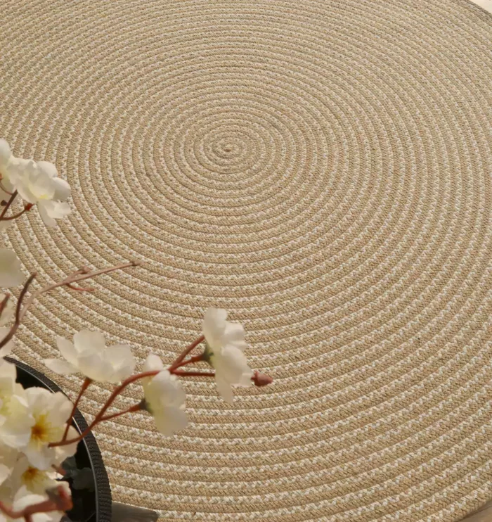 Handmade natural braided jute rug with eco-friendly design, rustic charm, and durable craftsmanship.