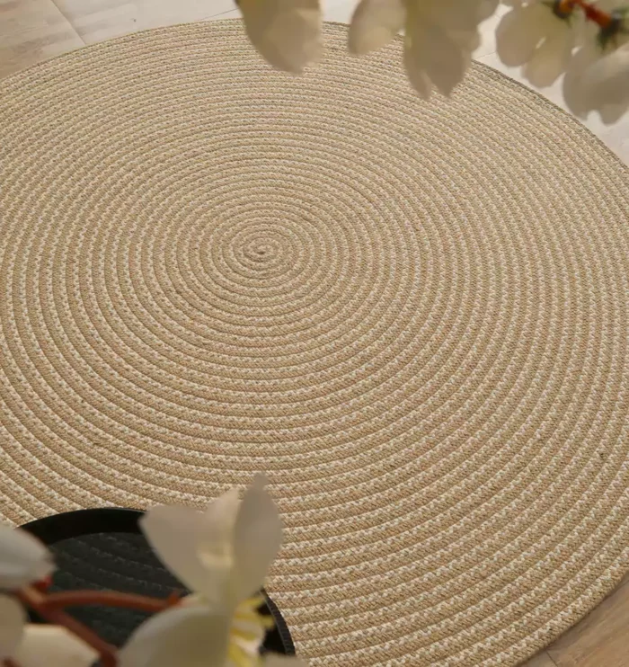 Handmade natural braided jute rug with eco-friendly design, rustic charm, and durable craftsmanship.