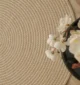 Handmade natural braided jute rug with eco-friendly design, rustic charm, and durable craftsmanship.