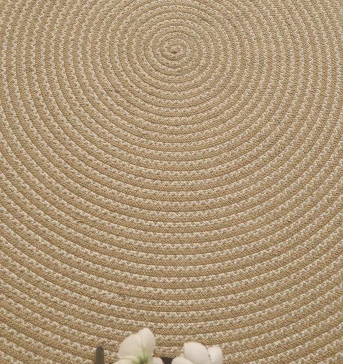 Handmade natural braided jute rug with eco-friendly design, rustic charm, and durable craftsmanship.