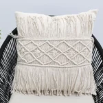 Natural white macrame cushion with handcrafted detailing, soft texture, and stylish home décor appeal.
