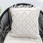 Natural white macrame cushion with handcrafted detailing, soft texture, and stylish home décor appeal.