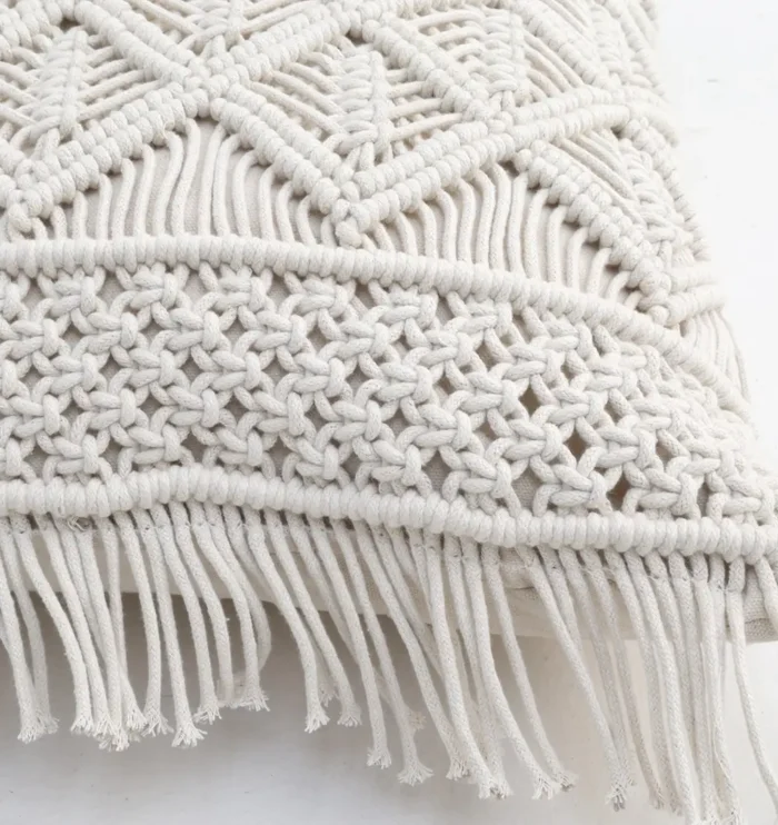 Natural white macrame cushion with handcrafted detailing, soft texture, and stylish home décor appeal.
