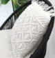 Natural white macrame cushion with handcrafted detailing, soft texture, and stylish home décor appeal.