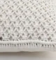 Natural white macrame cushion with handcrafted detailing, soft texture, and stylish home décor appeal.