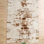 Machine-made rug with modern patterns, soft texture, and long-lasting durability for home décor.