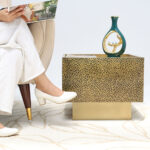 Golden square iron side table styled in a modern living room