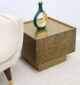 Close-up of textured golden finish on luxury square iron side table