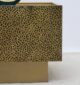 Side angle of square iron side table with textured golden antique design