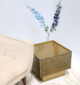 Golden square iron side table with antique brass finish on display