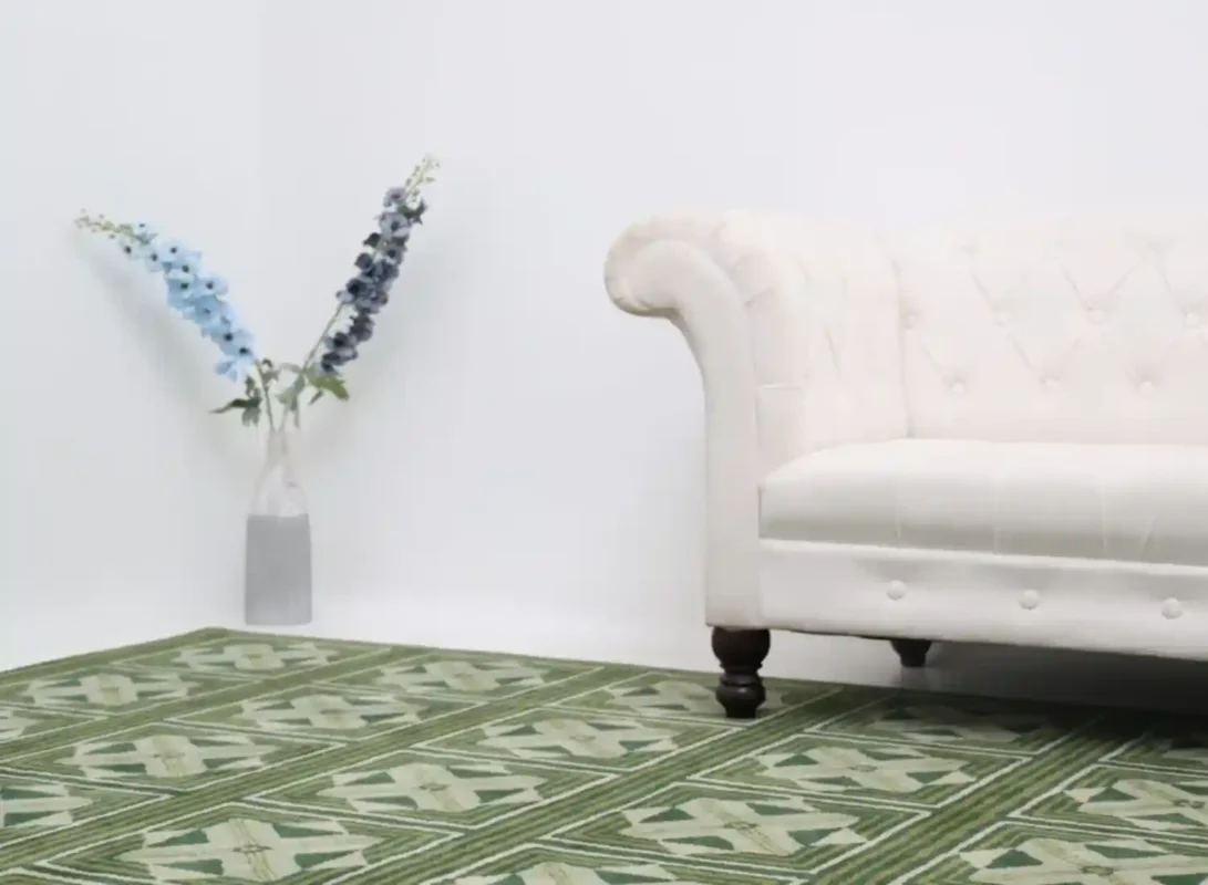 Wool rug under sofa with flower vase in corner of modern UAE home interior