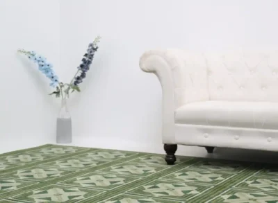 Wool rug under sofa with flower vase in corner of modern UAE home interior