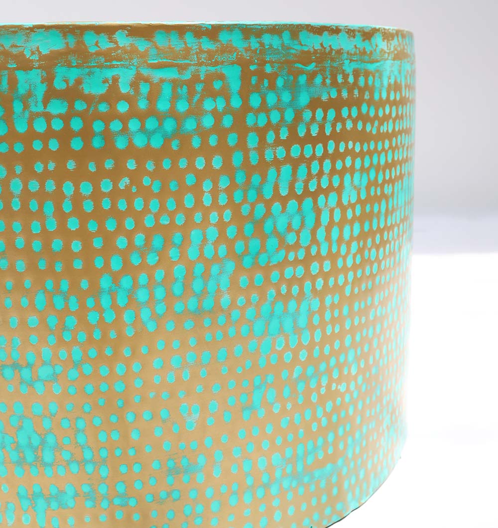Side Close-Up – Round Coffee Table with Turquoise Dot Pattern and Golden Base Side close-up of round coffee table showing turquoise dot pattern and golden iron base details