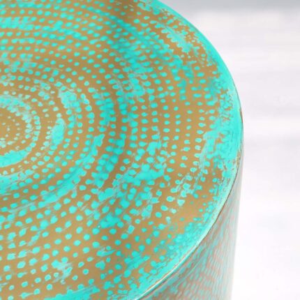Close-up top view of round coffee table showing turquoise dot pattern and golden edge details