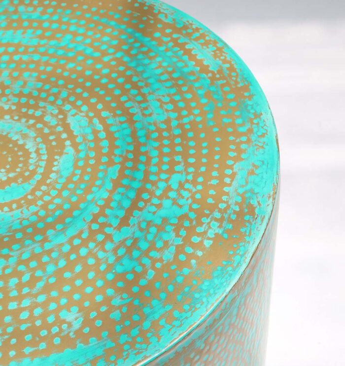 Close-up top view of round coffee table showing turquoise dot pattern and golden edge details