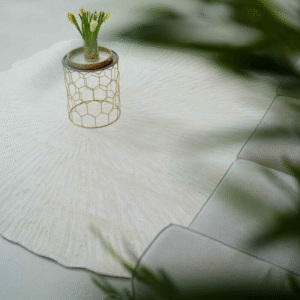 Area Rug with Decorative Item and Leaves – Stylish and Natural Interior Decor Area rug with decorative item on top and green leaves in front for cozy interior style