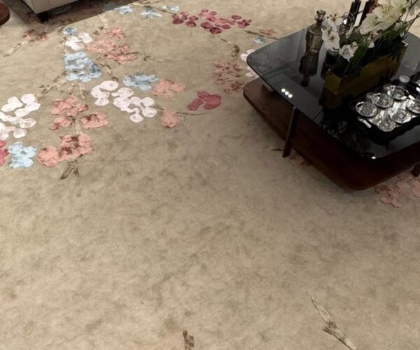 Hand-Tufted Wool Rug with a raised, textured cherry blossom floral design in pink, blue, and beige.