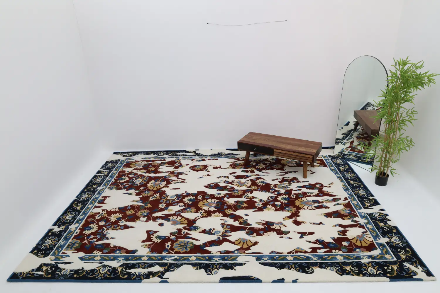 Traditional floral rug in a rectangular shape with dark blue and red botanical patterns on a cream base, featuring a classic, ornate border.