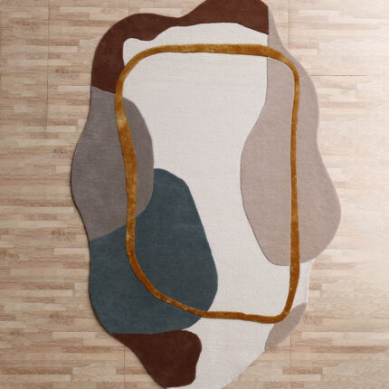 An Abstract Multi Color Shaped Area Rug featuring organic color blocks in brown, blue, and cream with a raised gold border.