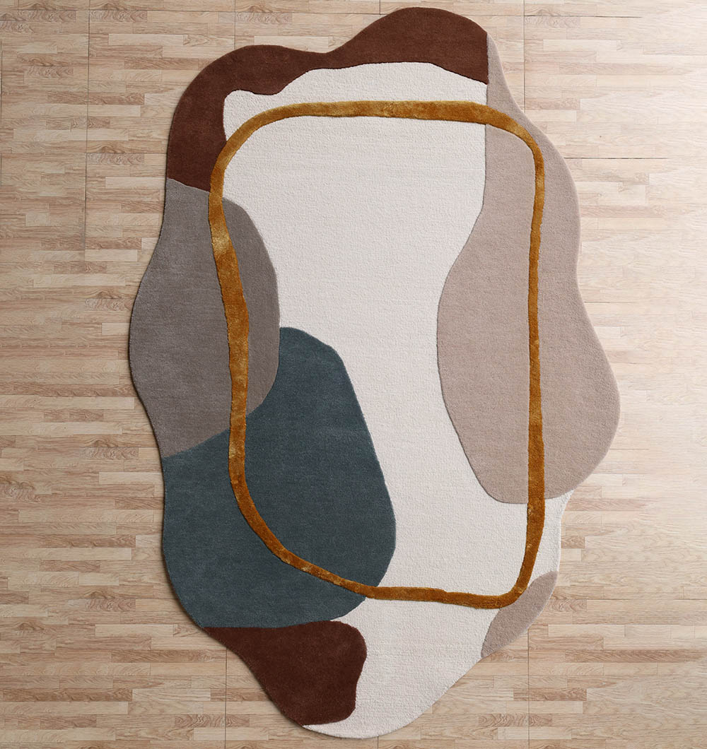 Abstract Multi Color Shaped Area Rug - HTWV 186` An Abstract Multi Color Shaped Area Rug featuring organic color blocks in brown, blue, and cream with a raised gold border.