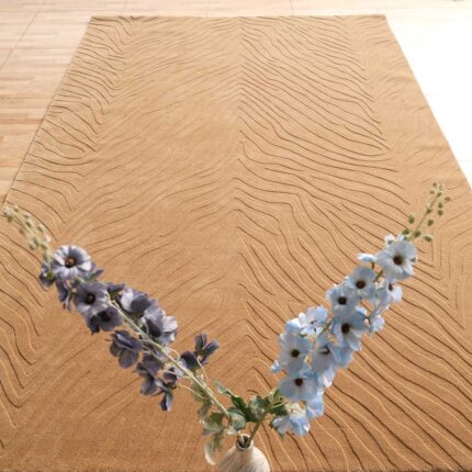 A large Beige Rectangle Rug featuring a hand-carved rhythmic stripe pattern on a light wooden floor.