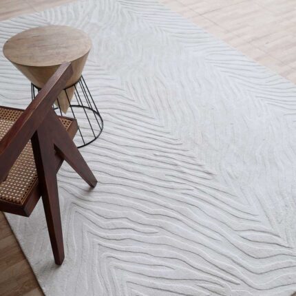 A rectangular White Color Area Rug featuring a hand-carved zebra-stripe pattern and high-sheen Tencel finish.