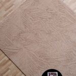 A high-quality entry for cotton rugs featuring a handmade beige rectangle carpet with a deep, hand-carved linear pattern.