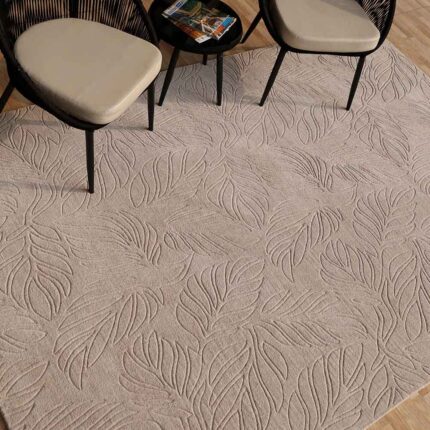 A premium example of living room rugs featuring an all-over hand-carved botanical leaf pattern in grey.