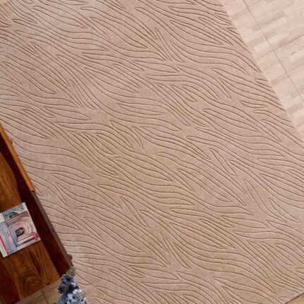 A premium example of bedroom carpets featuring a handmade beige rectangle rug with a deep, hand-carved architectural texture.